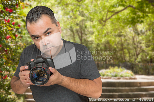 Image of Hispanic Young Male Photographer With DSLR Camera Outdoors