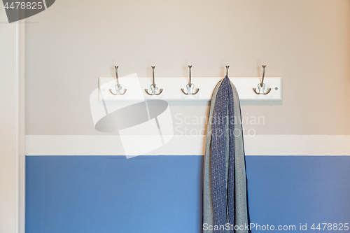 Image of Wall in House with Scarf Hanging on Coat Rack Hooks Abstract