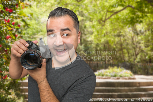 Image of Hispanic Young Male Photographer With DSLR Camera Outdoors