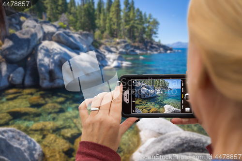 Image of Woman Taking A Beautiful Lake Picture with Her Smart Phone