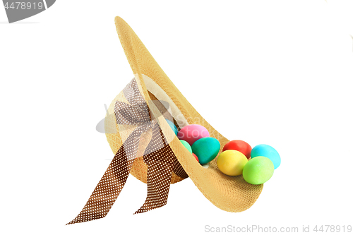 Image of Easter dyed eggs in spring fashioned woman hat 