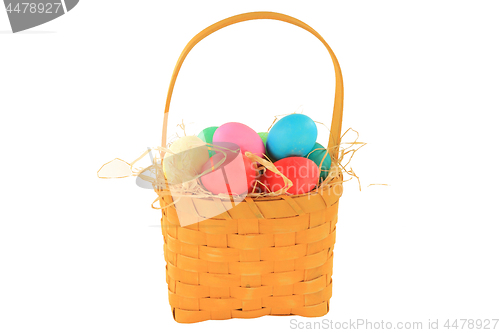 Image of Easter dyed eggs in wooden square shaped basket 