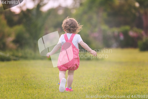 Image of little girl spending time at backyard