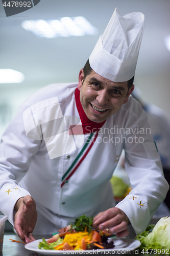 Image of chef serving vegetable salad