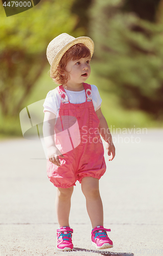 Image of little girl runing in the summer Park