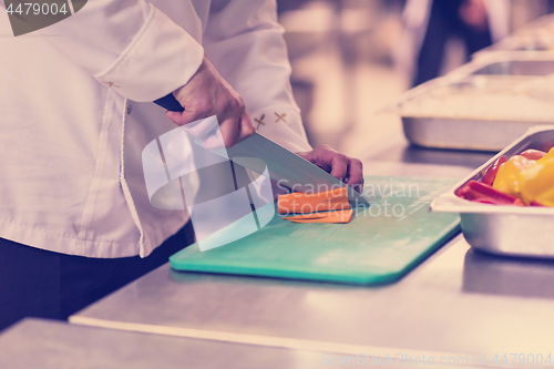 Image of Chef hands cutting fresh and delicious vegetables