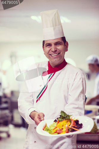 Image of Chef showing a plate of tasty meal