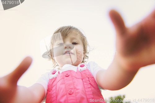 Image of little girl spending time at backyard