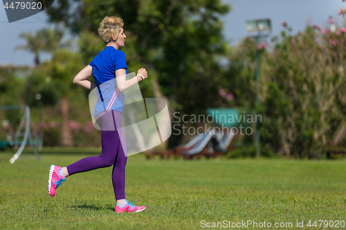 Image of young female runner training for marathon