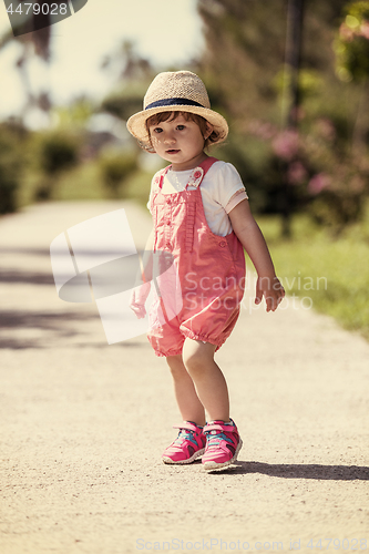 Image of little girl runing in the summer Park