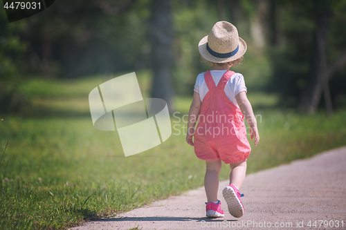 Image of little girl runing in the summer Park