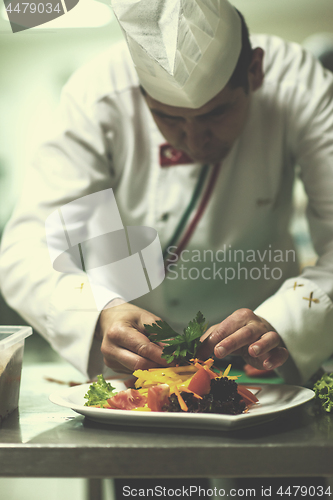 Image of chef serving vegetable salad