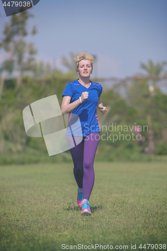 Image of young female runner training for marathon