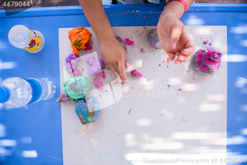 Image of kid hands Playing with Colorful Clay