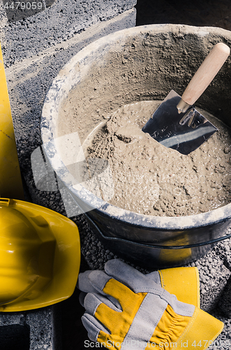Image of Tools for bricklayer bucket with a solution and a trowel, close-