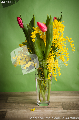 Image of Spring bouquet with mimosa and tulips in a vase