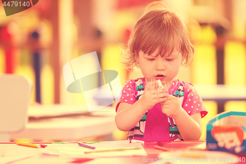 Image of little girl drawing a colorful pictures