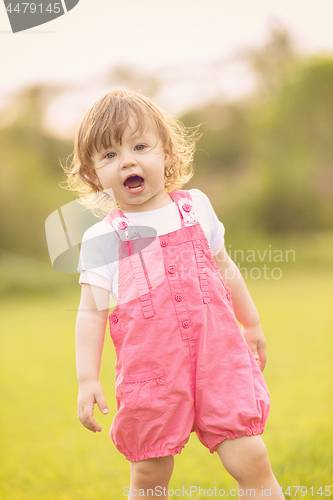 Image of little girl spending time at backyard