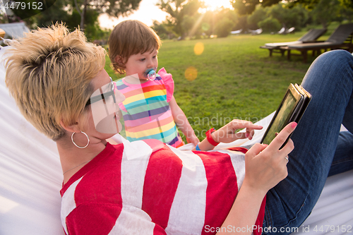 Image of mom and a little daughter relaxing in a hammock