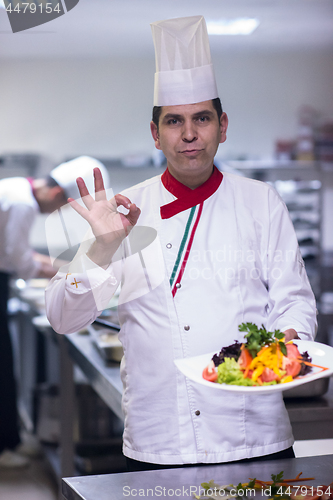 Image of Chef showing a plate of tasty meal