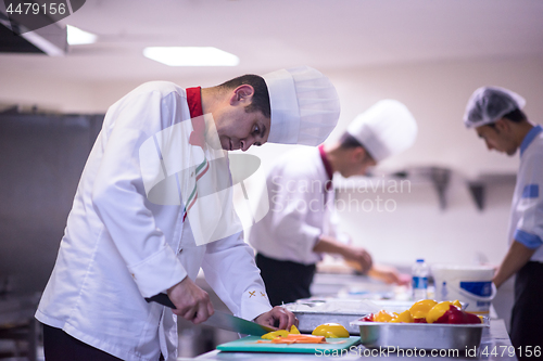 Image of Chef cutting fresh and delicious vegetables