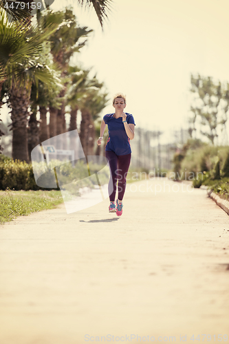 Image of young female runner training for marathon