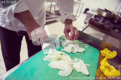 Image of Chef hands cutting fresh and delicious vegetables