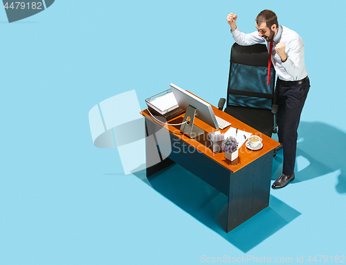 Image of Shot from above of a stylish business man working on a laptop.