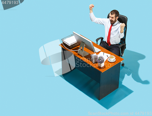 Image of Shot from above of a stylish business man working on a laptop.