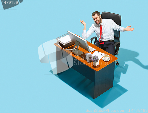 Image of Shot from above of a stylish business man working on a laptop.