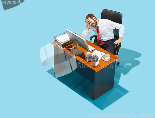 Image of Shot from above of a stylish business man working on a laptop.