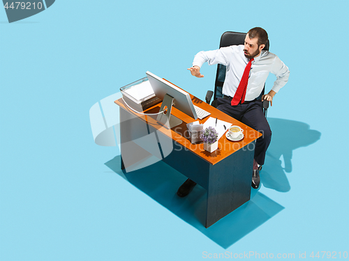 Image of Shot from above of a stylish business man working on a laptop.