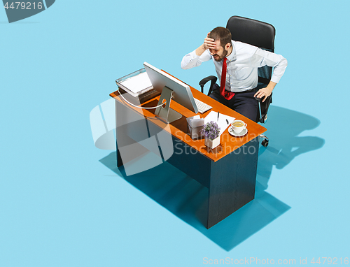 Image of Shot from above of a stylish business man working on a laptop.