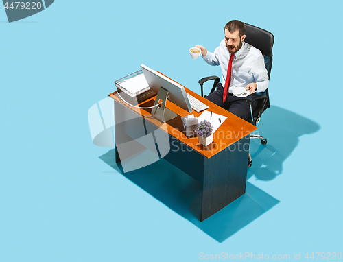 Image of Shot from above of a stylish business man working on a laptop.