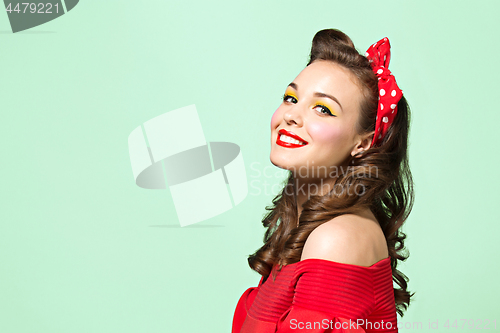 Image of Beautiful young woman with pinup make-up and hairstyle. Studio shot on white background