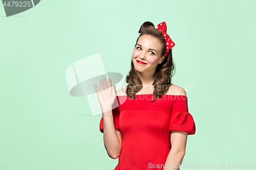 Image of Beautiful young woman with pinup make-up and hairstyle. Studio shot on white background