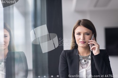 Image of Business Girl Standing In A Modern Building Near The Window With