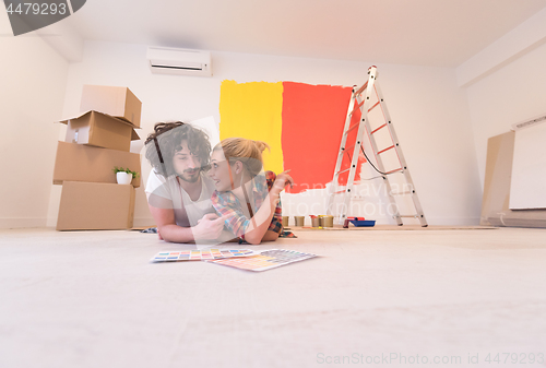 Image of Happy young couple relaxing after painting