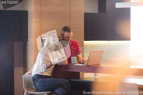 Image of happy young couple buying online