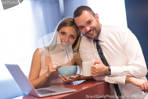 Image of A young couple is preparing for a job and using a laptop