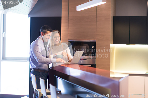 Image of A young couple is preparing for a job and using a laptop