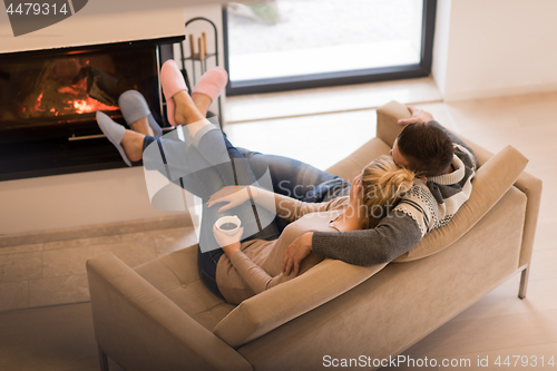 Image of Young couple  in front of fireplace