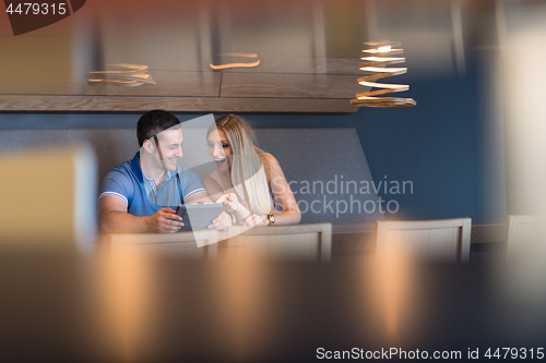 Image of couple using tablet at home