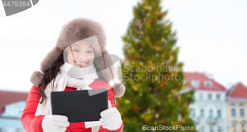 Image of woman with tablet pc over christmas tree