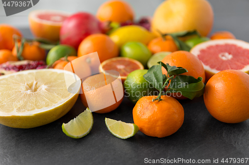 Image of close up of citrus fruits on stone table