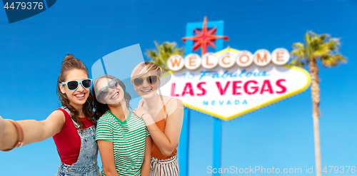 Image of female friends taking selfie over las vegas sign