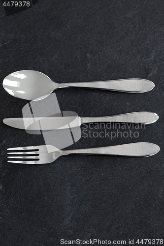 Image of close up of fork, knife and spoon on table