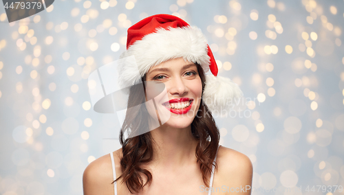 Image of woman with red lipstick in santa hat on christmas