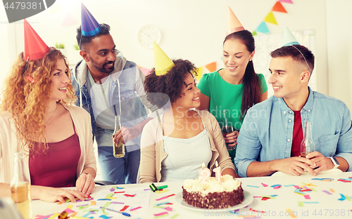 Image of team greeting colleague at office birthday party