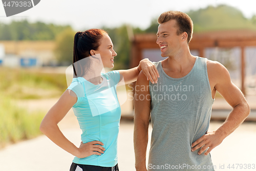 Image of happy couple in sports clothes outdoors